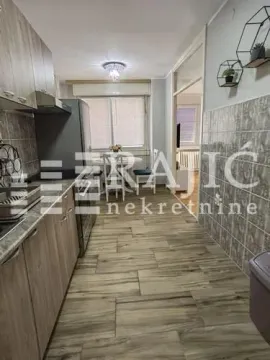 Kitchen with dining area and wooden elements. - image 10