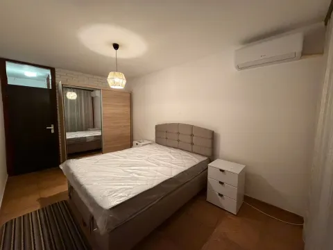 Furnished bedroom with a double bed, wardrobe, and air conditioning. - image 4