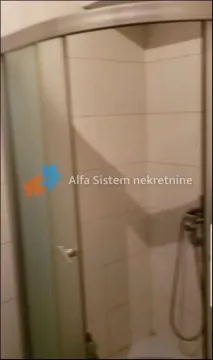 A shower cabin in a bathroom with white wall tiles. - image 12