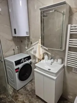 Compact bathroom with a sink, washing machine, and water heater. - image 23