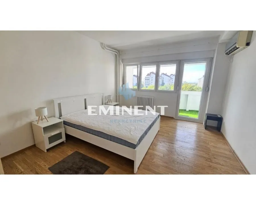 Bedroom with a double bed, bedside tables, and access to the terrace.