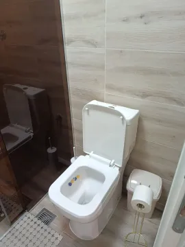 Modern bathroom with a toilet and a shower cabin. - image 14