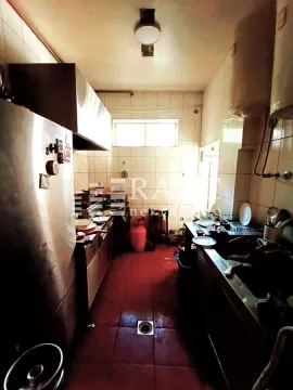 Older and untidy kitchen with dishes and work elements. - image 6