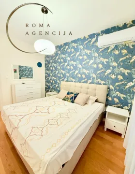 Furnished bedroom with a double bed and patterned wallpaper. - image 5