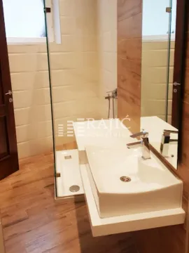 Modern bathroom with a sink and a shower cabin. - image 11