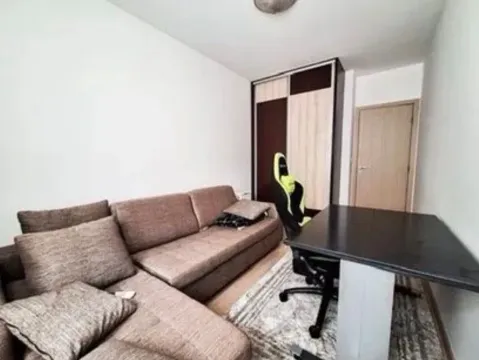 Living room with a corner sofa, desk, and wardrobe. - image 7