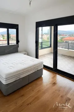 Bedroom with a double bed, hardwood flooring, and access to the terrace. - image 4