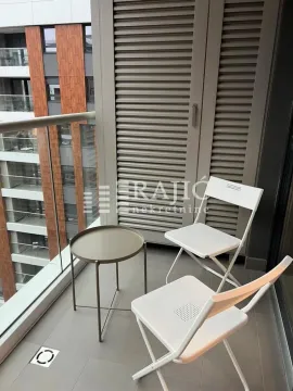 Small covered terrace with a small table and two chairs. - image 9