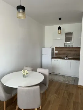 Bright kitchen with a dining table. - image 7