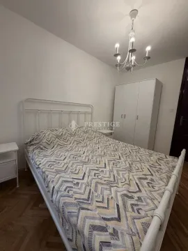 Furnished bedroom with a double bed, wardrobe, and chandelier. - image 7