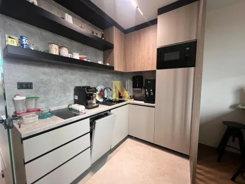 Modern corner kitchen with built-in appliances and open shelving. - image 10