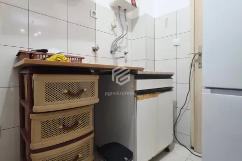 Small kitchen with a sink, wall tiles, and base cabinets. - image 10