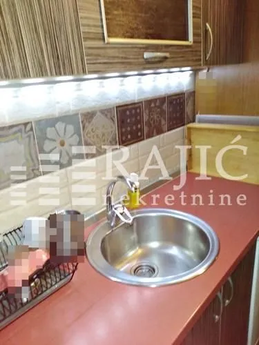 View of the kitchen sink and cabinets.