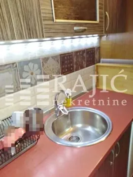 View of the kitchen sink and cabinets. - image 13