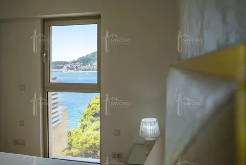 Bedroom with a window and a sea view. - image 8