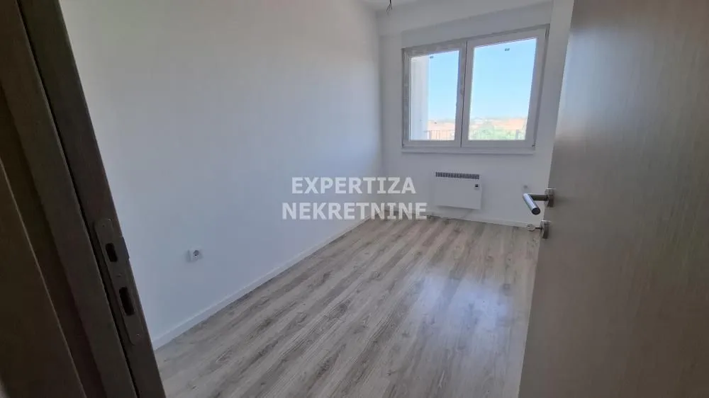 Empty room with laminate flooring and a window.