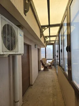 Enclosed terrace with seating area and air conditioning unit. - image 2