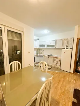 Kitchen with a dining area and light wooden cabinetry. - image 2