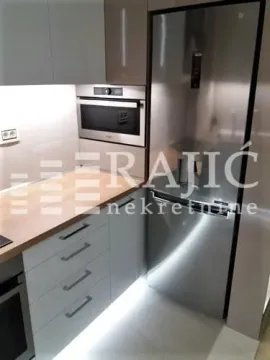 Modern kitchen with built-in appliances and cabinetry. - image 5
