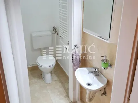 Smaller bathroom with a toilet and a sink. - image 7