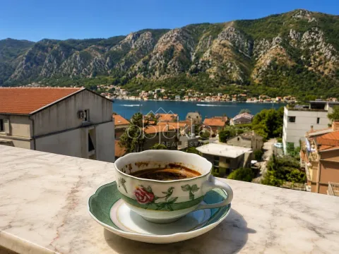 A cup of coffee on a marble terrace overlooking the sea and mountains. - image 2