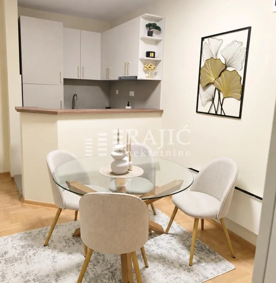 Dining area with a table and chairs overlooking the kitchen.