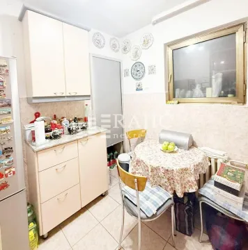 Smaller kitchen with a dining table and chairs. - image 6