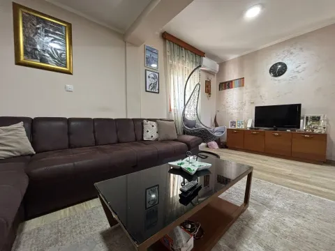 Spacious living room with a brown sectional sofa and television. - image 5