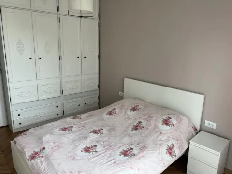 Furnished bedroom with a double bed and a white wardrobe. - image 4