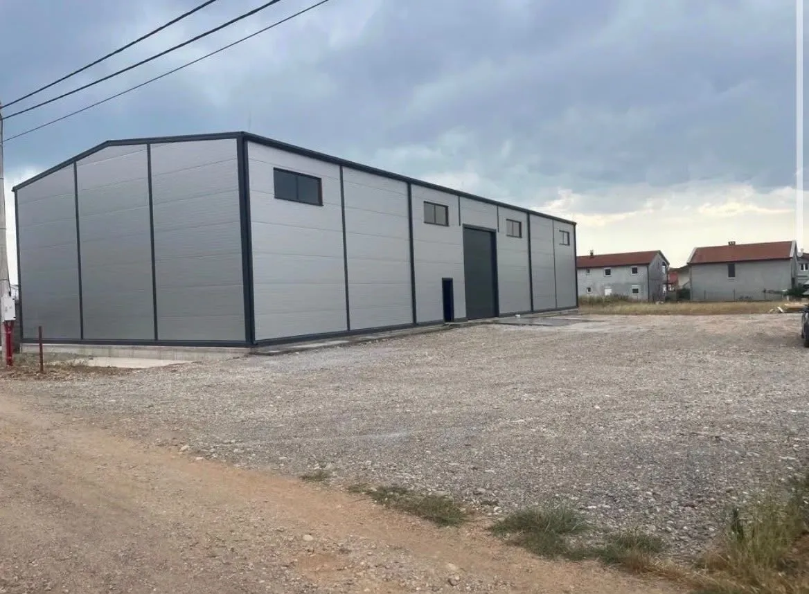 View of the exterior of an industrial building with a large courtyard.
