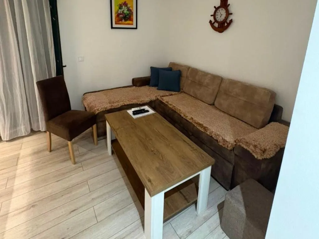 Living room with a sectional sofa, a wooden coffee table, and a chair.