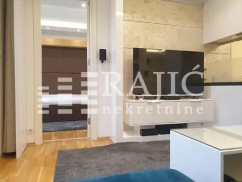 Modern living room with a TV and a view into the bedroom. - image 11