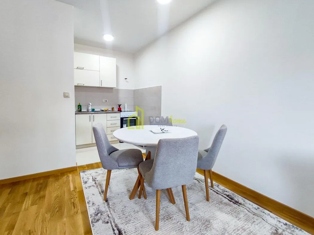 Small kitchen with a dining table and chairs.