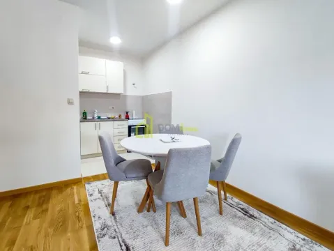 Small kitchen with a dining table and chairs. - image 6