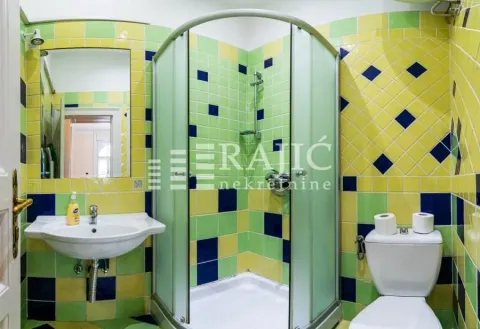 Bathroom with a shower cabin and colorful tiles. - image 17