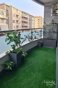 Balcony with artificial grass and potted plants. - image 4