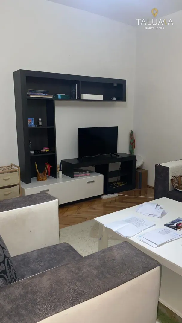 Living room with a sofa set, coffee table, and TV unit.