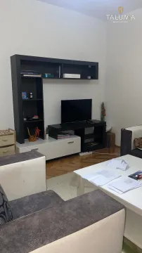 Living room with a sofa set, coffee table, and TV unit. - image 3