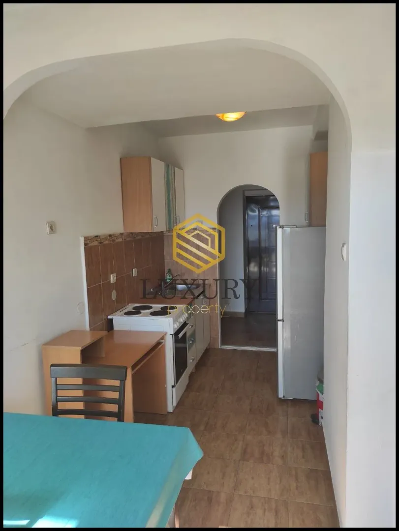 Small kitchen with a dining table and basic units.