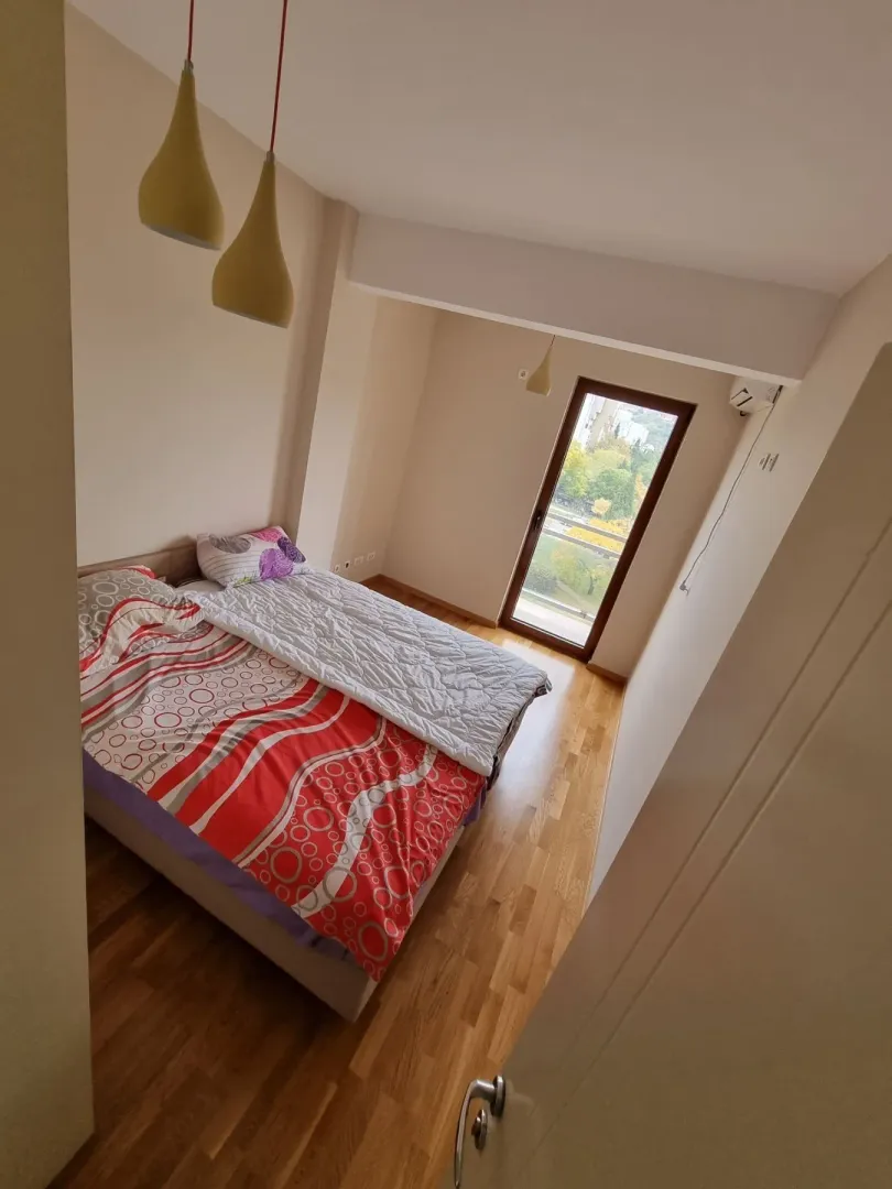 Bright bedroom with a double bed and access to a balcony.
