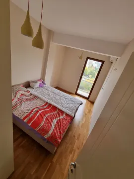 Bright bedroom with a double bed and access to a balcony. - image 5