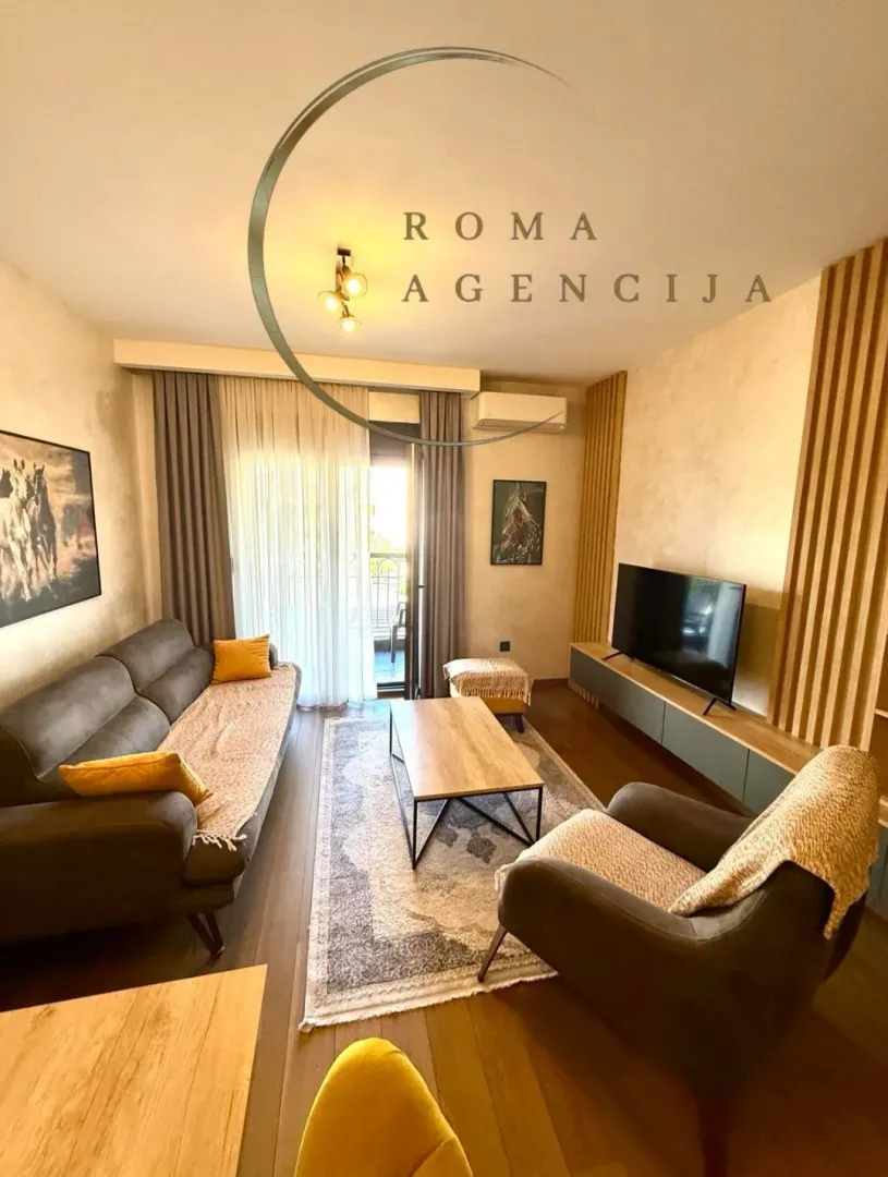 Furnished living room with a sofa, coffee table, and TV.