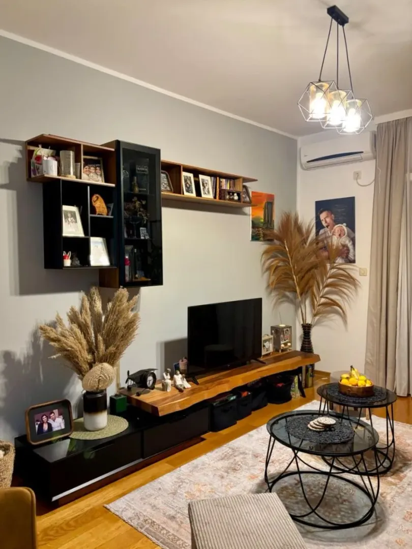 Living room with a TV unit and modern furniture.