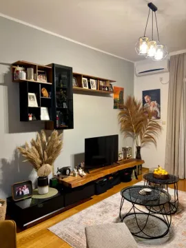 Living room with a TV unit and modern furniture. - image 5