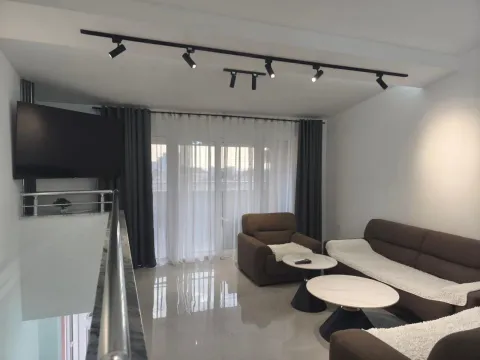 Living room with sofa set, coffee tables, and TV. - image 2