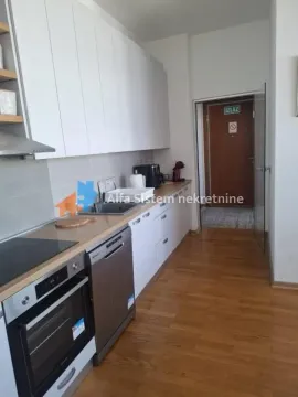 Modern kitchen with white cabinetry and built-in appliances. - image 3