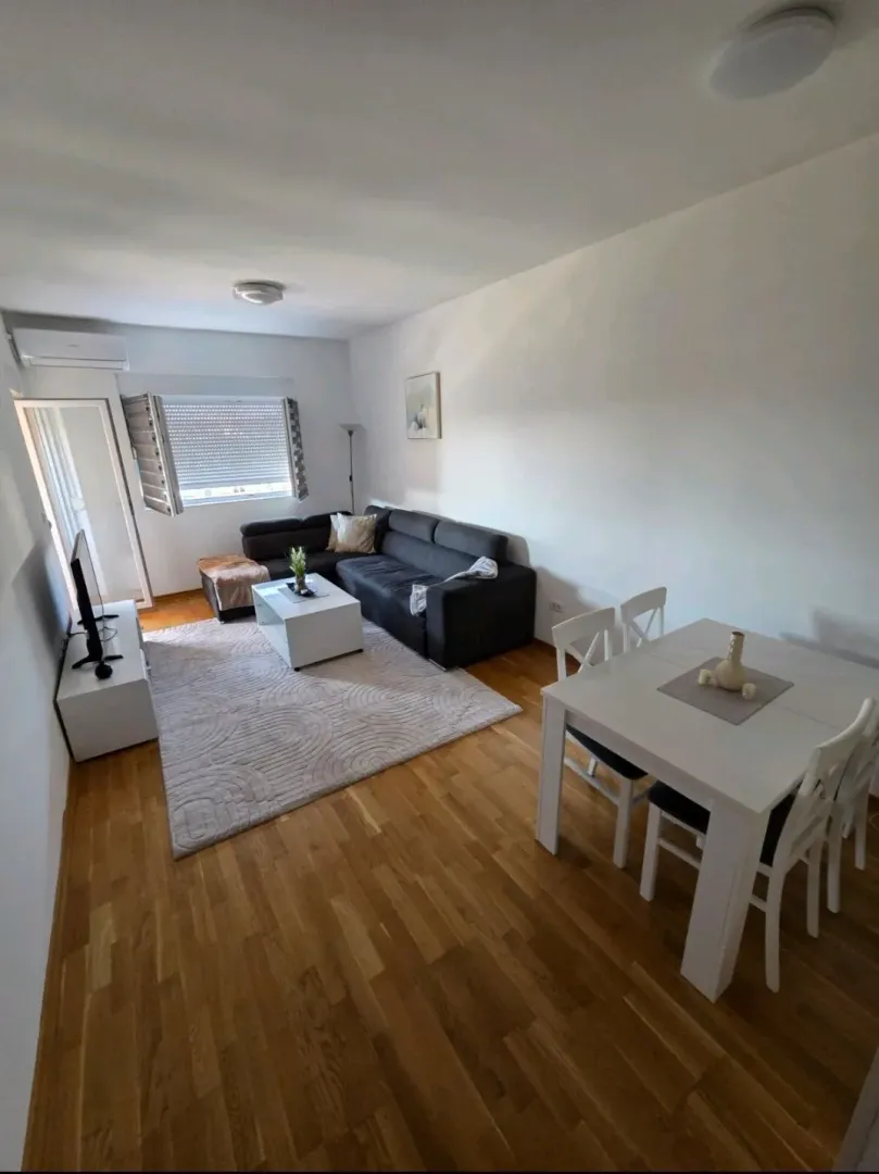 Dnevni boravak sa garniturom i trpezarijskim stolom.