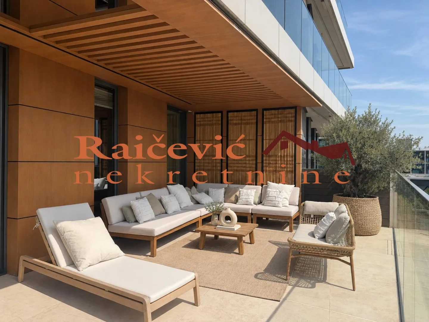 Spacious furnished terrace with seating furniture and a sun lounger.