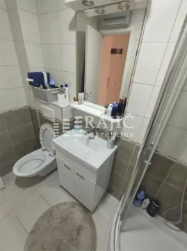Smaller bathroom with a sink, toilet, and shower cabin. - image 10