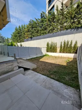 Private courtyard with a paved area and a lawn. - image 18